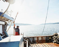 Fisherman standing on a fishing boat on a sunny day