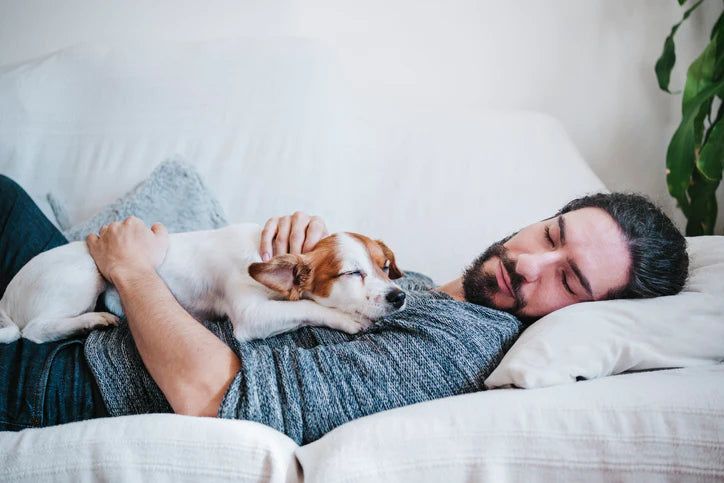 Man sleeping with dog.