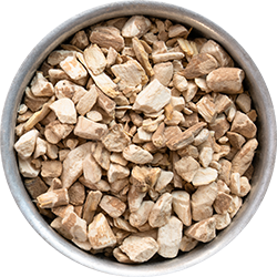 A round metal bowl filled with small, irregularly shaped pieces of light brown and beige plant material.