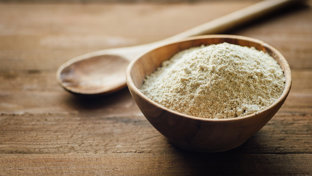 Powdered quercetin in a wooden bowl on a wooden counter top